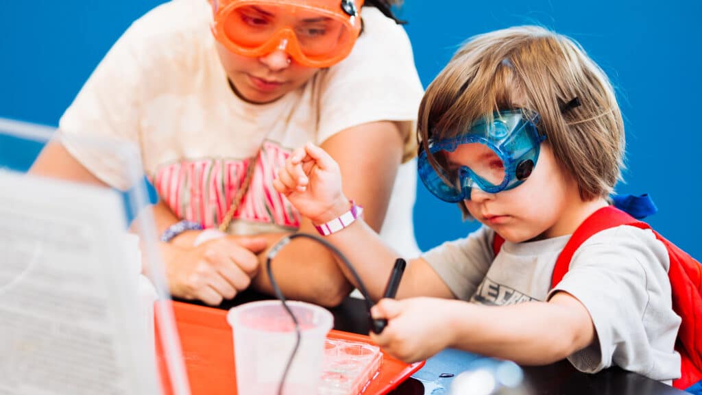 Two students in the OMSI chemistry lab learning about the chemistry of food.