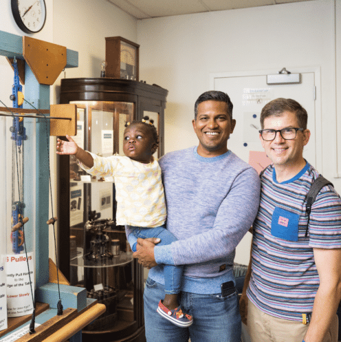 Family posing for a photo in the OMSI Physics Lab